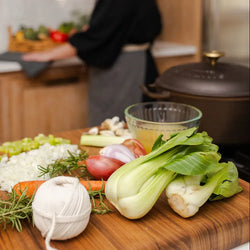 Person preparing kitchen and vegetables for a cooking class