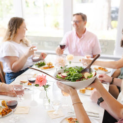 Couples gathering around a table for a meal after a cooking class