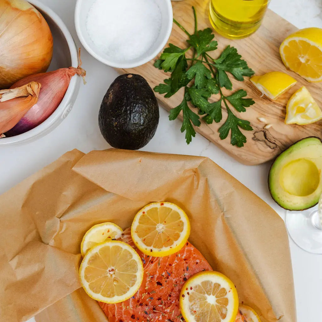 Salmon filet being prepared in a cooking class with other seasonal ingrediants.